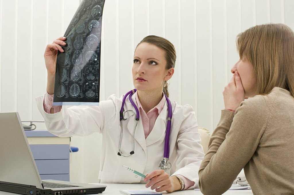Doctor checking the report of a patient